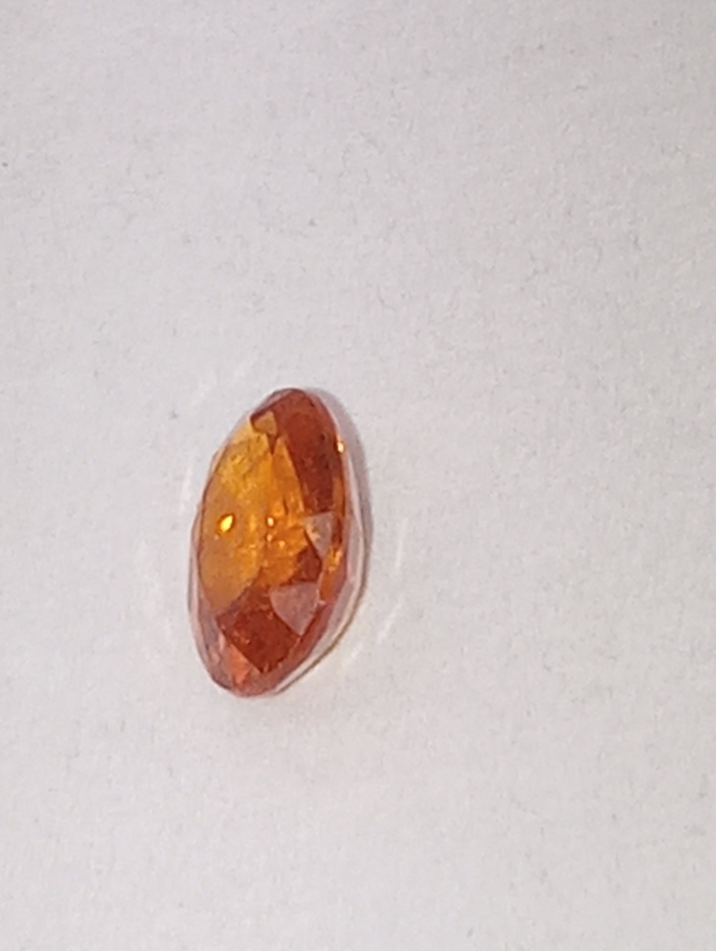 garnet gemstone mandarin spessartite, 6mmx4mm oval cut, .60ct