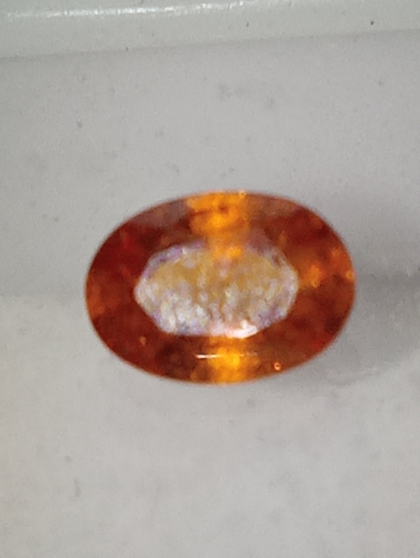 garnet gemstone mandarin spessartite, 6mmx4mm oval cut, .60ct
