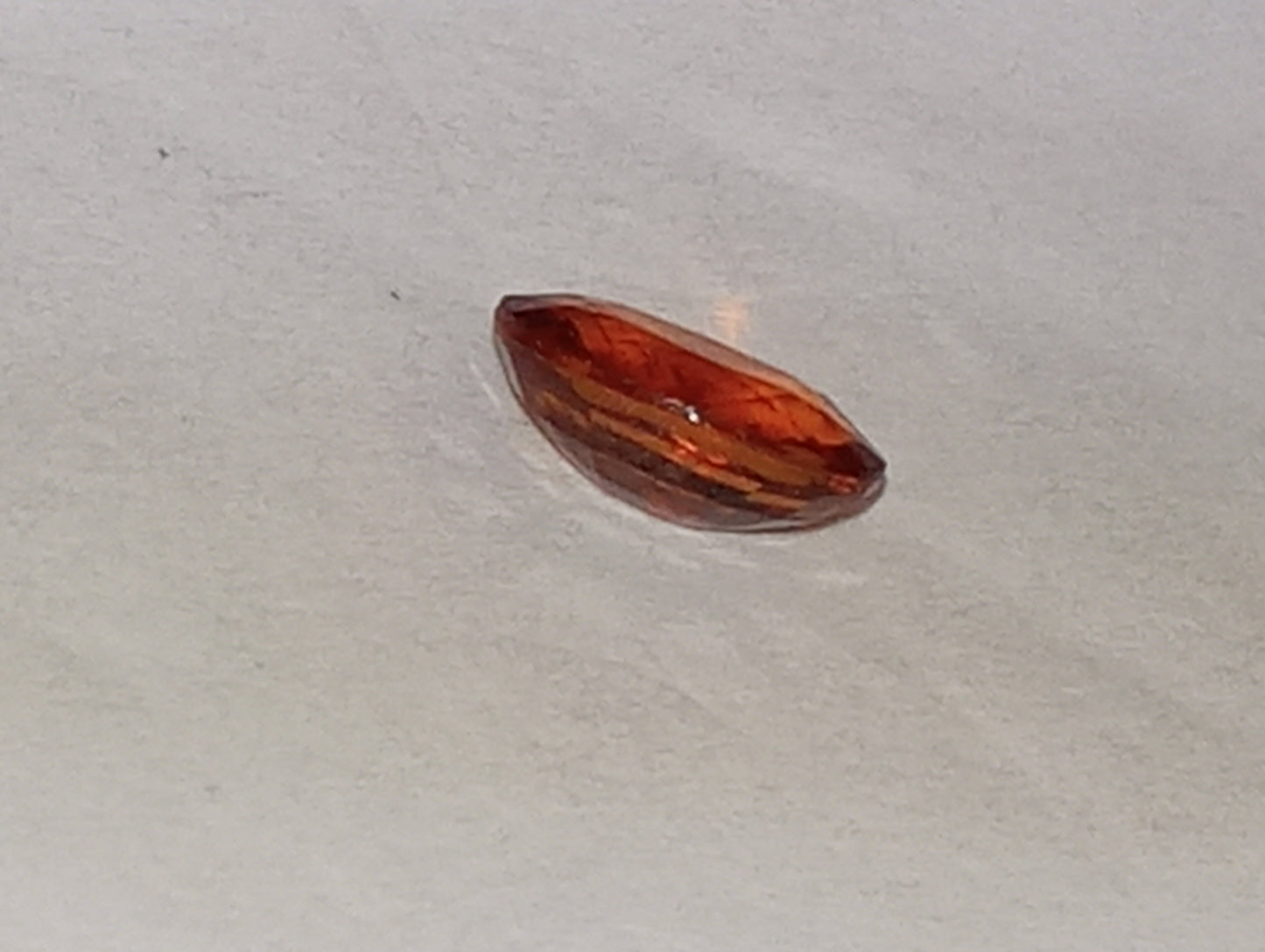 garnet gemstone Spessartite, 6mm x4mm oval cut, .62ct