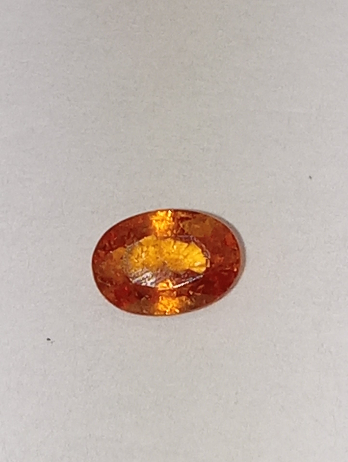 garnet gemstone mandarin spessartite, 6mmx4mm oval cut, .60ct
