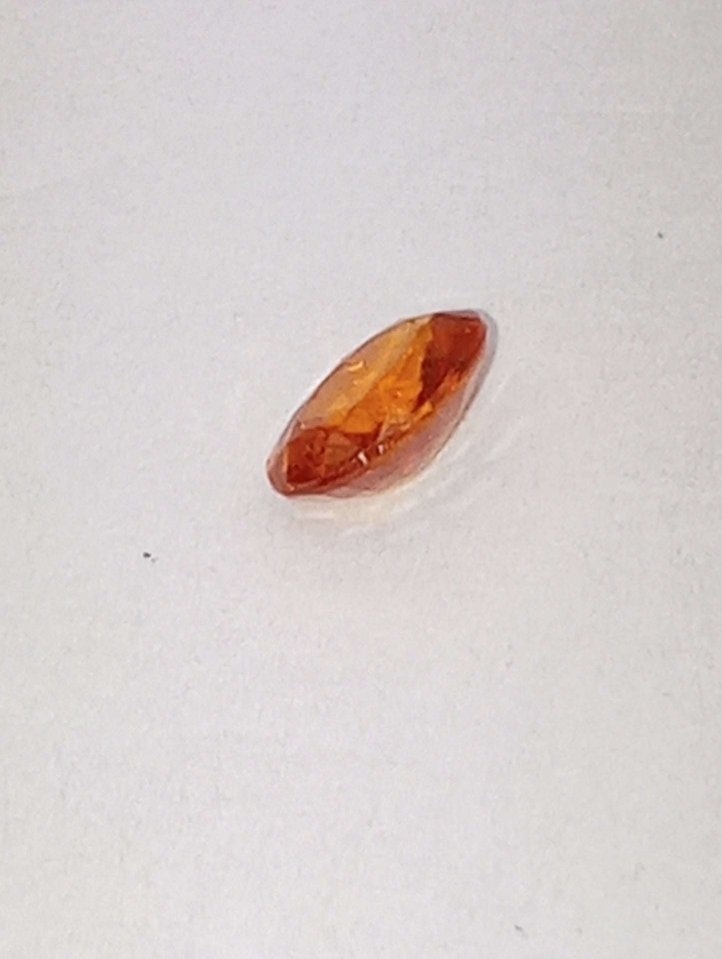 garnet gemstone mandarin spessartite, 6mmx4mm oval cut, .60ct