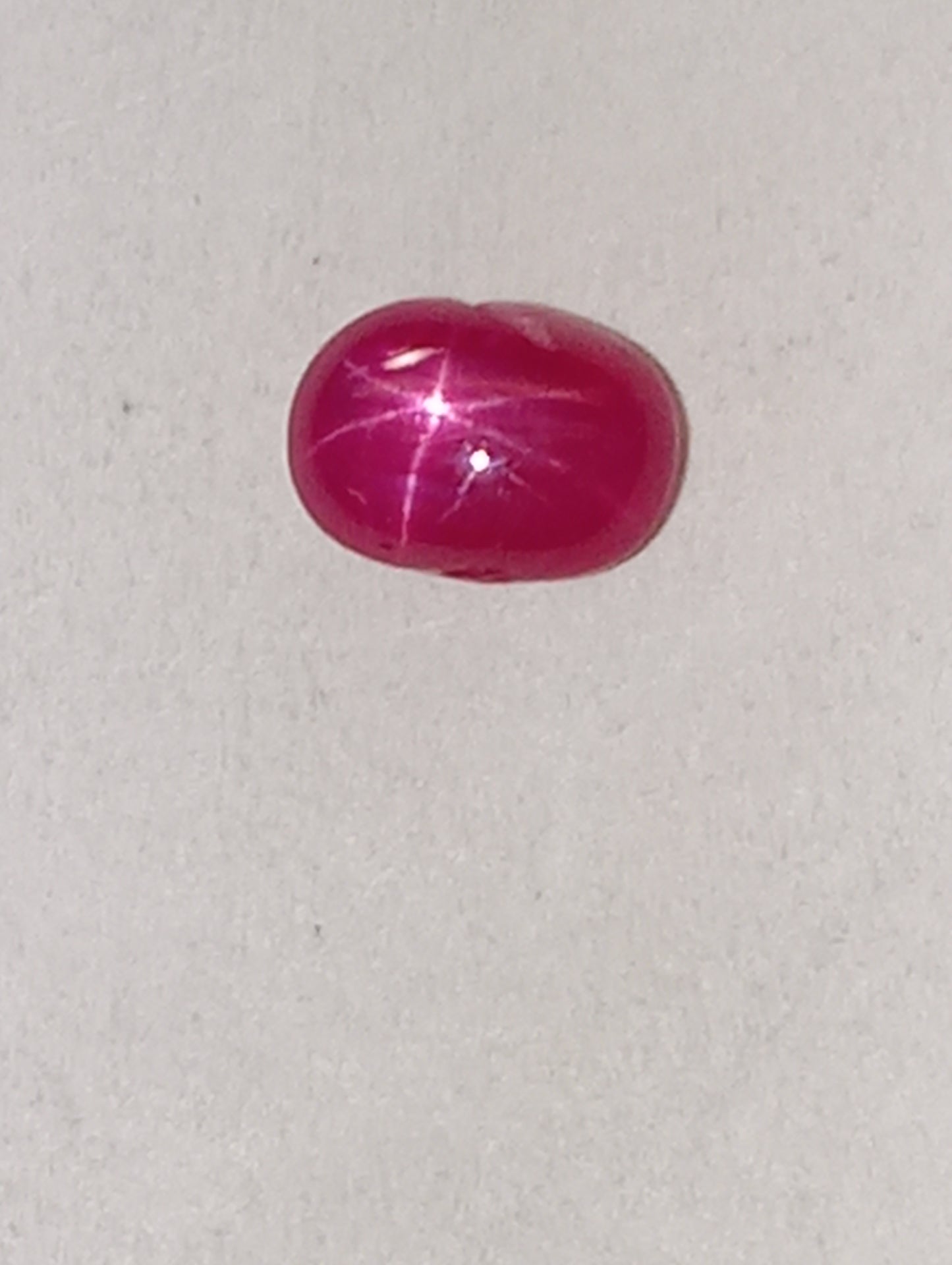 ruby gemstone Burma star, .92ct, 5.5mmx4mm oval cabocon,