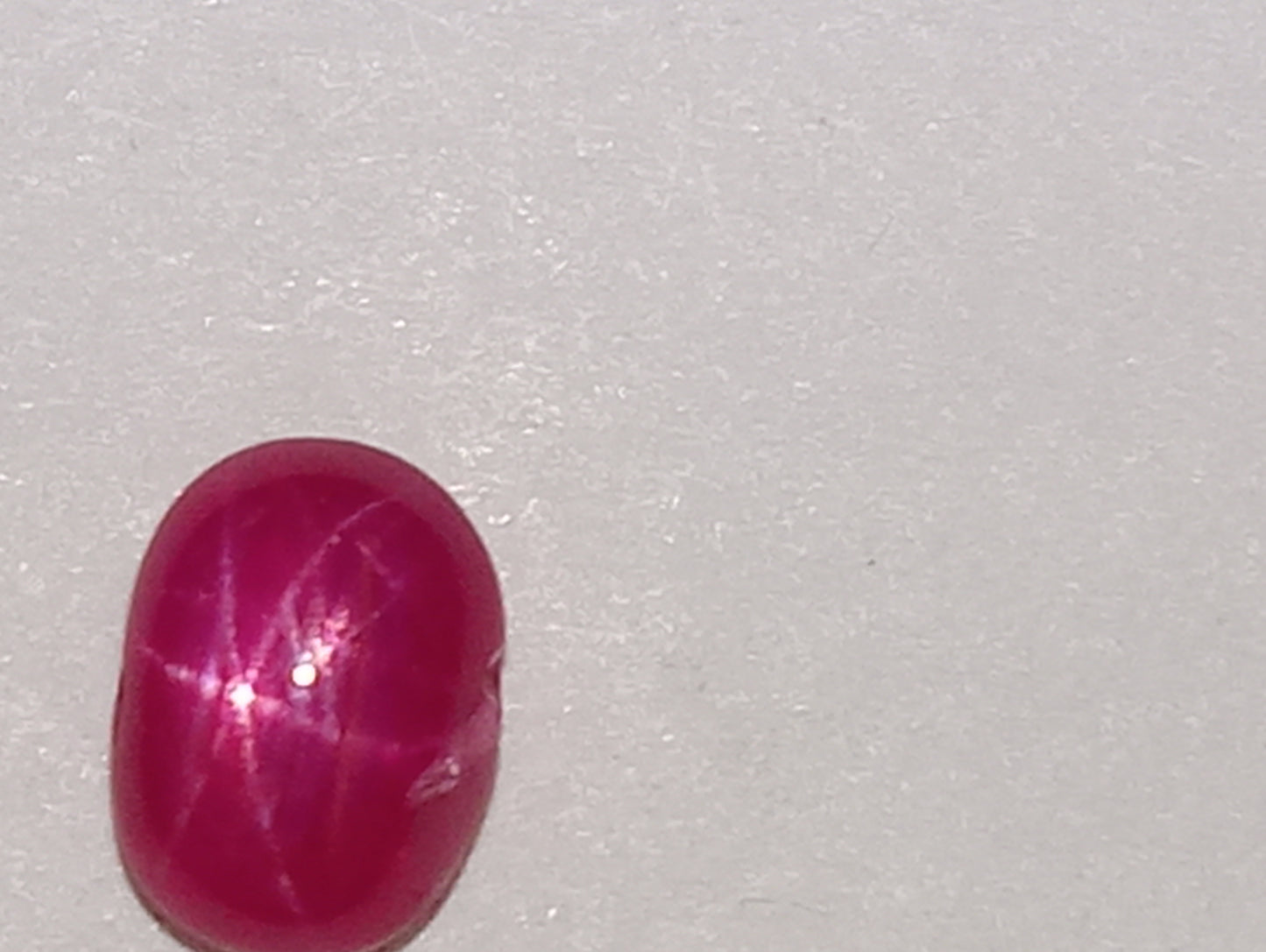ruby gemstone Burma star, .92ct, 5.5mmx4mm oval cabocon,