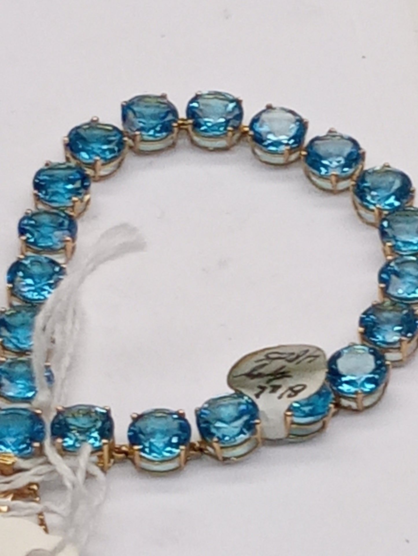 bracelet Swiss blue topaz rounds in 10k yellow gold, 48ctw