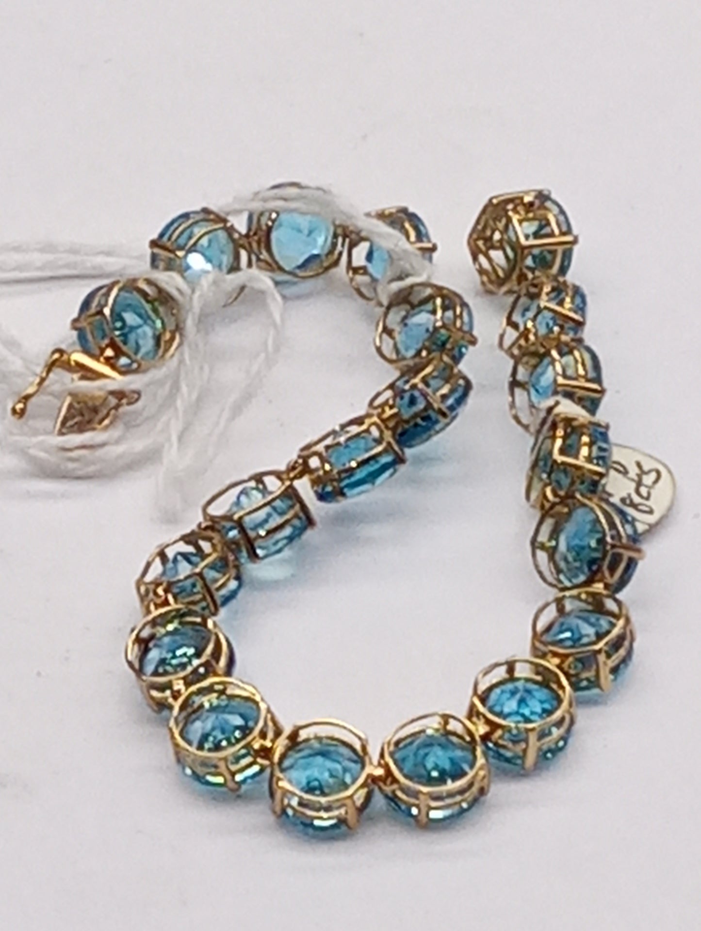 bracelet Swiss blue topaz rounds in 10k yellow gold, 48ctw