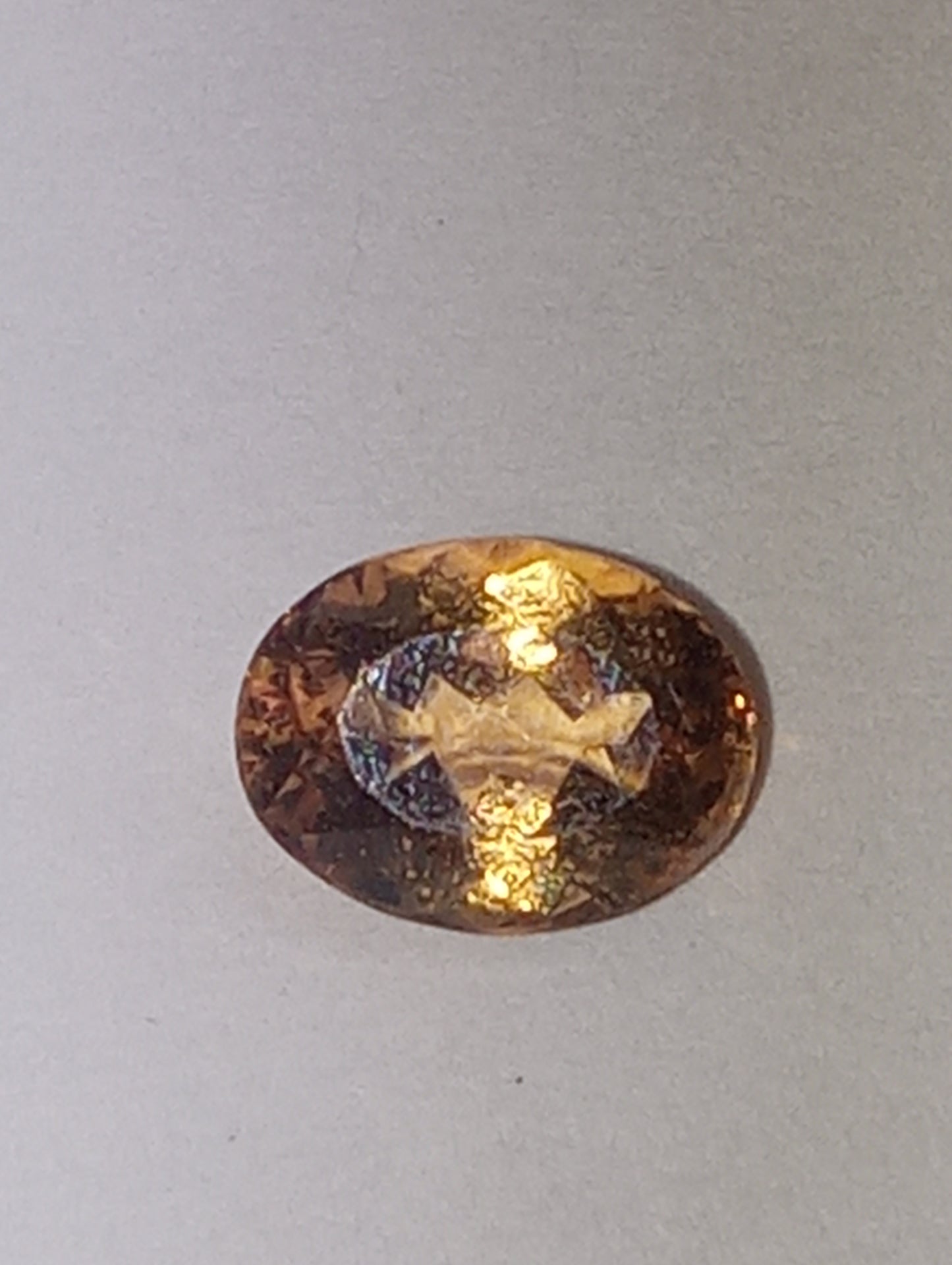 Topaz gemstone Imperial, golden with slightly pink undertones, 7mmx5.5mm oval cut, 1.07ct