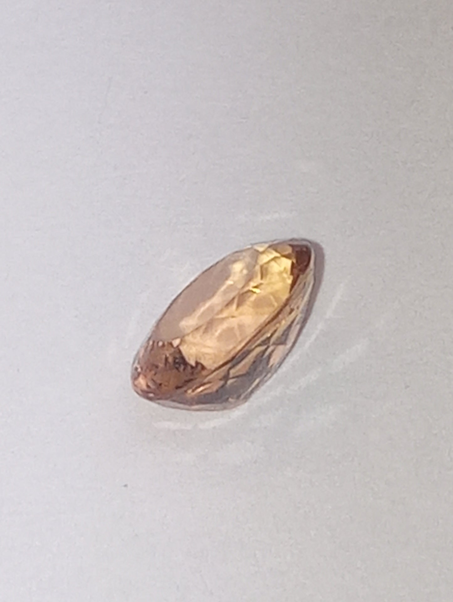 Topaz gemstone Imperial, golden with slightly pink undertones, 7mmx5.5mm oval cut, 1.07ct
