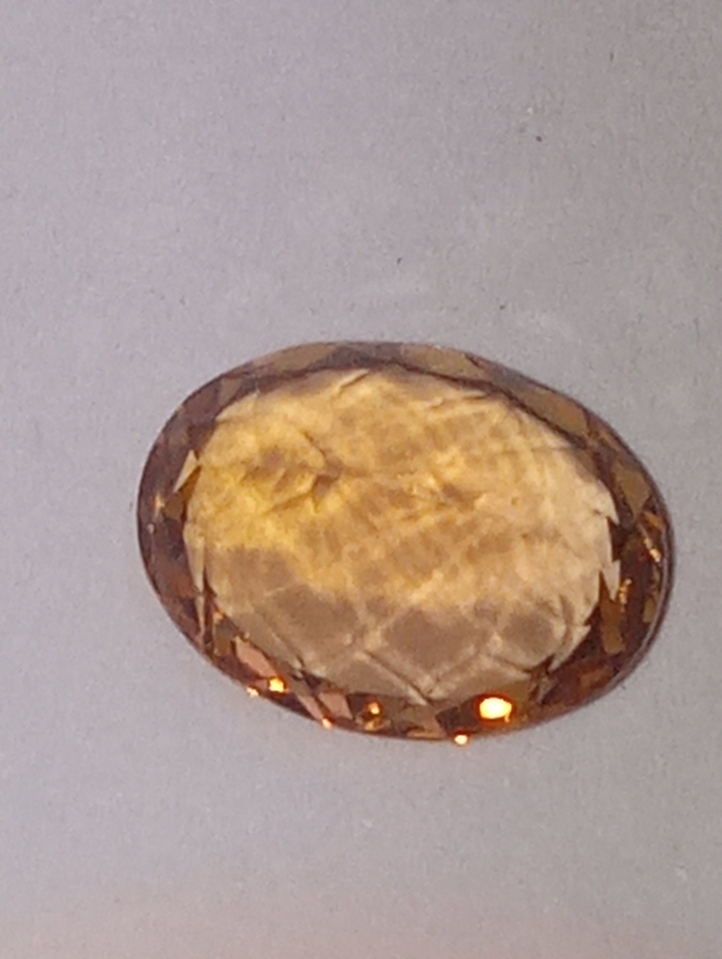 Topaz gemstone Imperial, golden with slightly pink undertones, 7mmx5.5mm oval cut, 1.07ct
