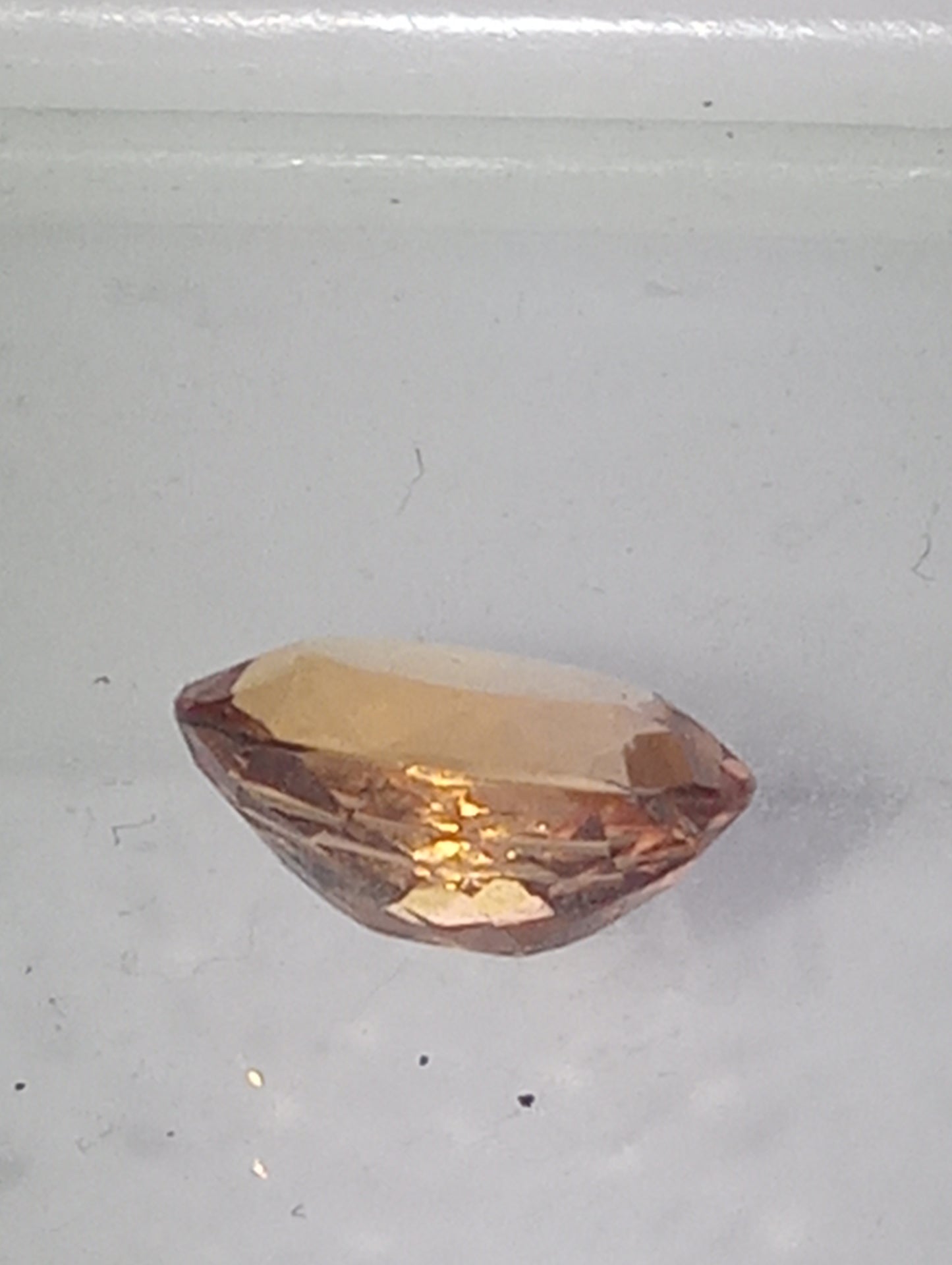 Topaz gemstone Imperial, golden with slightly pink undertones, 7mmx5.5mm oval cut, 1.07ct